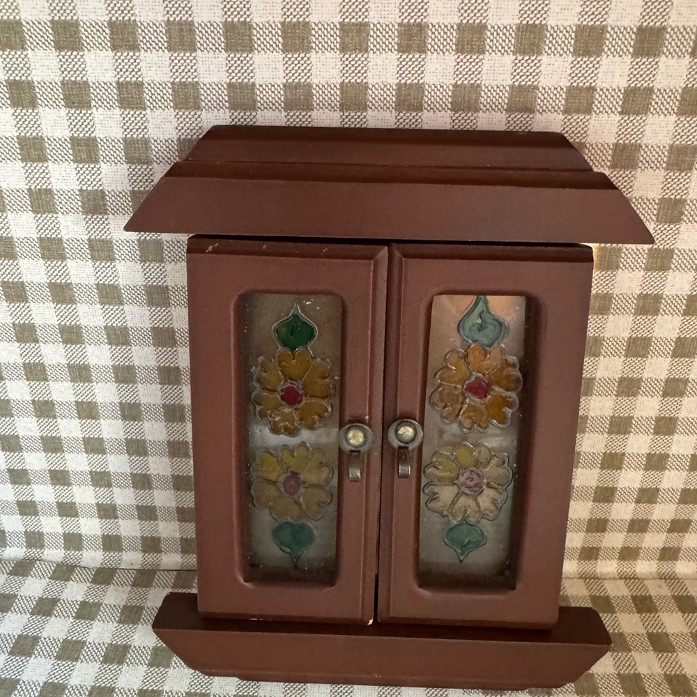 Decorative wall accent featuring doors with faux stained glass floral panel